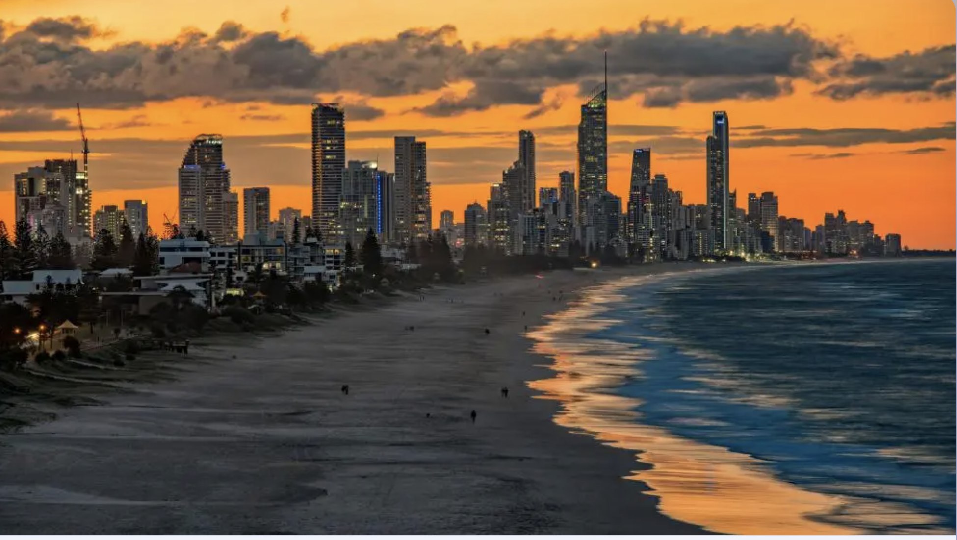 Gold Coast skyline and beach at sunset with an orange sky