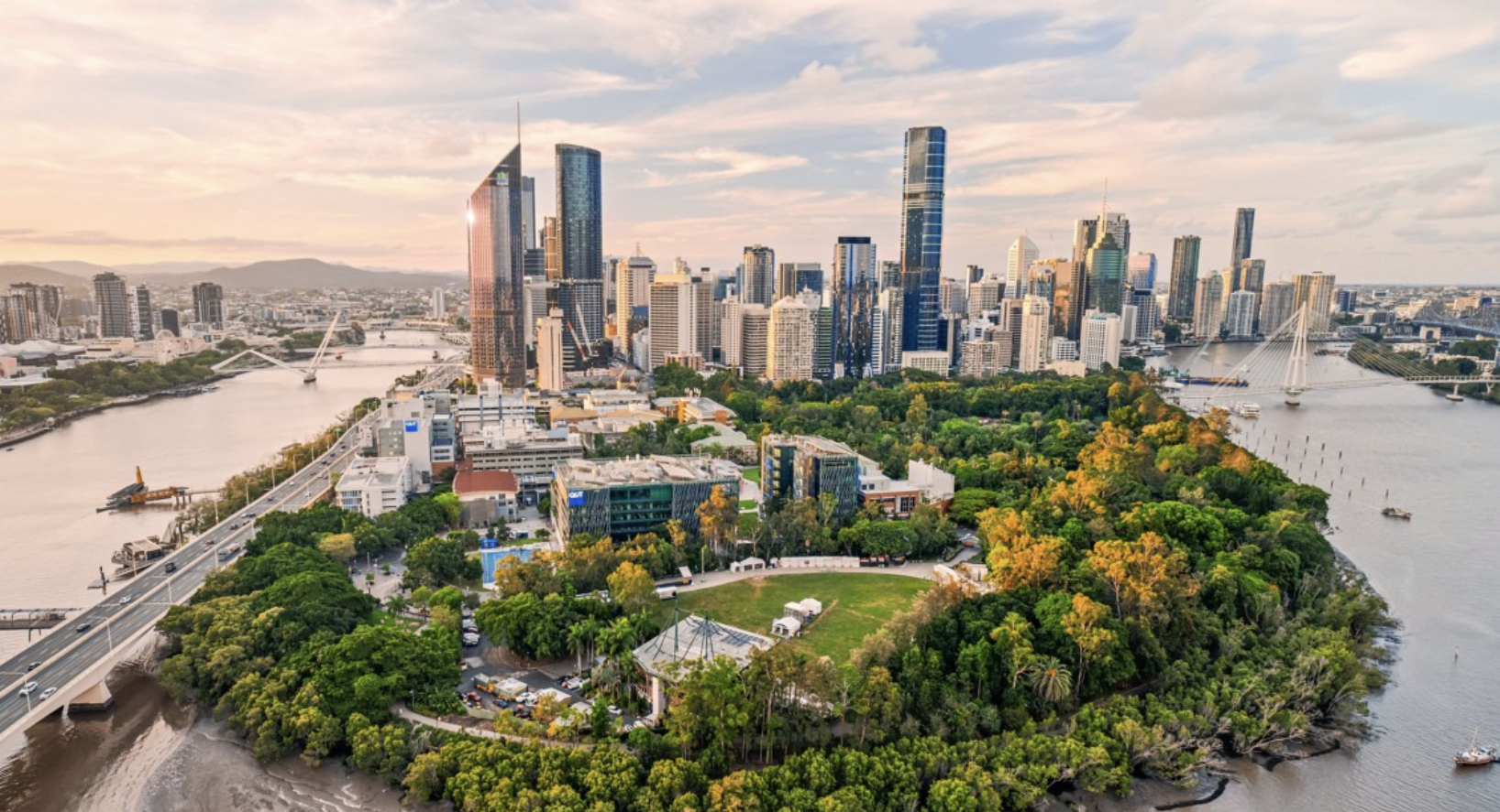 Aerial view of the Brisbane skyline and river at sunset
