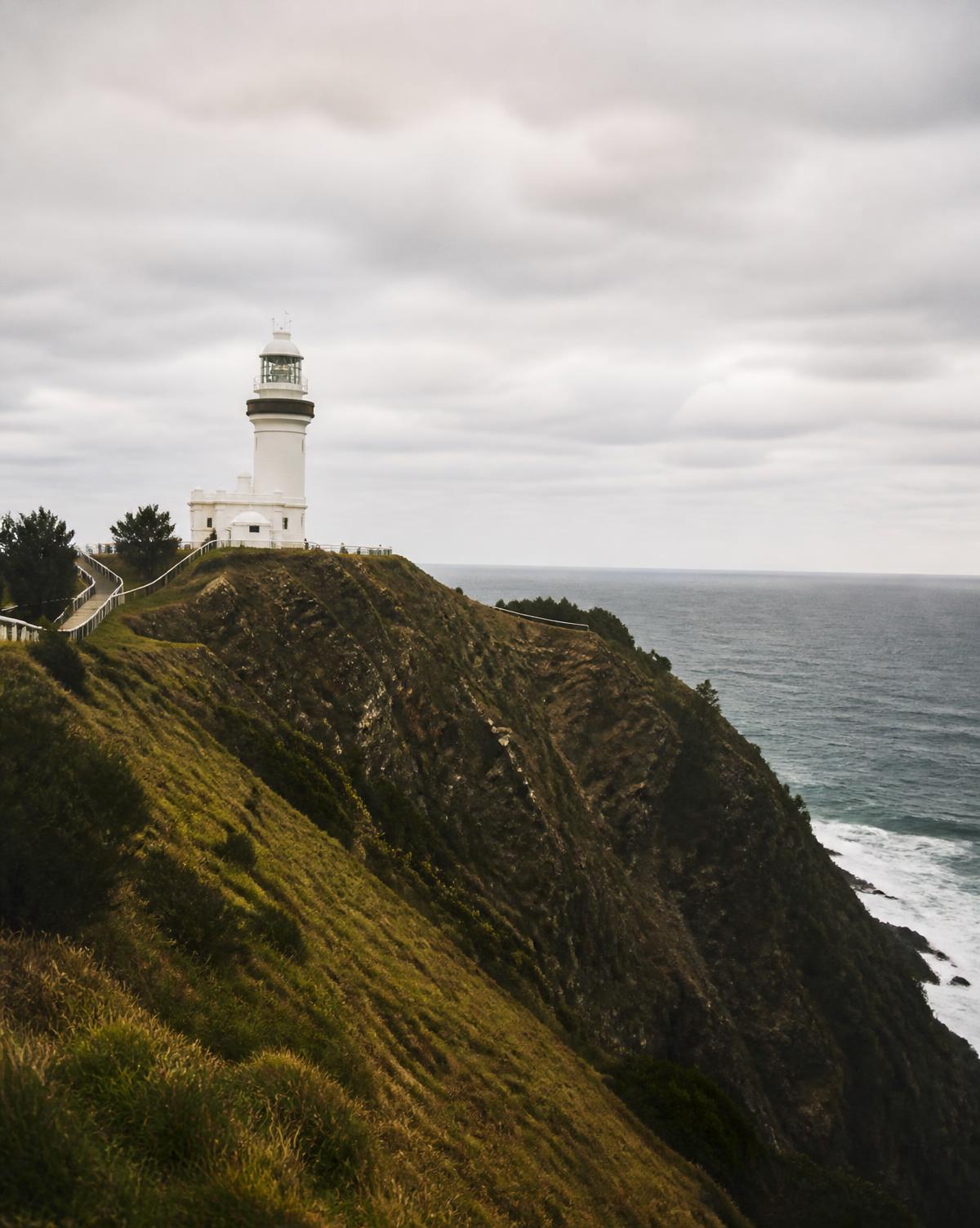 Byron Bay lighthouse on a green headland above the ocean